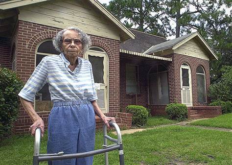 Julia Lemon stands outside home she defended from eminent domain laws. 